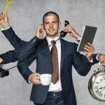 Business Man Multi-Tasking With Clock Practising Good Time Management Skills