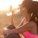 Woman Drinking Water After A Workout