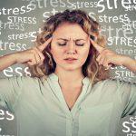 oung Woman Looking Stressed With The Word Stress Written Behind Her