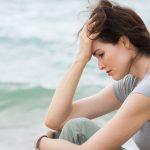 Woman Looking Down In The Dumps On The Beach