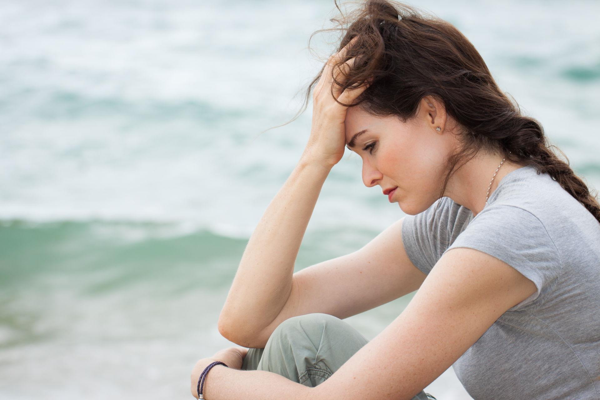 Woman Looking Down In The Dumps On The Beach